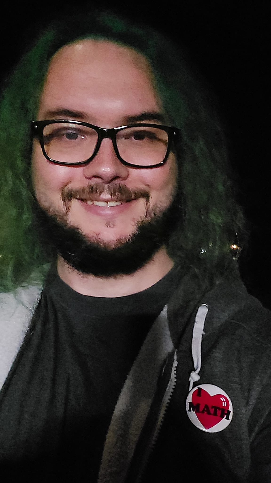 A man with green hair is at the beach after dark, photo 4